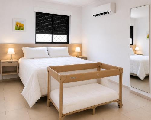 a bedroom with a large bed and a mirror at Atlantic Ocean Residence in Fortaleza