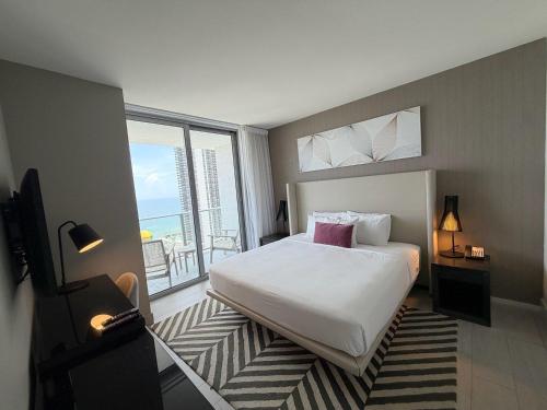 a bedroom with a bed and a large window at Steps from the Beach - Amazing Views in Hollywood