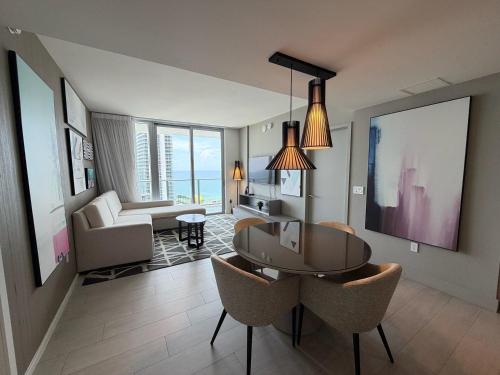 a living room with a table and chairs in a room at Steps from the Beach - Amazing Views in Hollywood