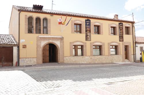 a building on a street in front of a building at Posada San Miguel Arcángel Experience in Arévalo