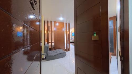 a hallway with a door and a bed in a room at Azure Stays Patong in Patong Beach