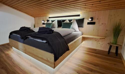 a bedroom with a large bed in a wooden room at Apartment Wegmo in Bischofshofen