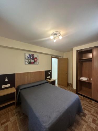 a hotel room with a bed and a cabinet at Peregrino in Pontevedra