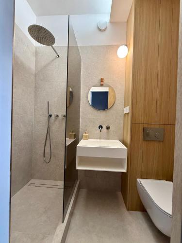 a bathroom with a sink and a shower at Apartmán Thea in Komárno