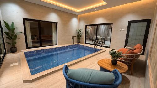 a large swimming pool in a living room at Abu Rakan Apartment in Muscat