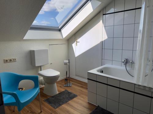 a bathroom with a toilet and a skylight at Fewo Bad Salzuflen in Bad Salzuflen