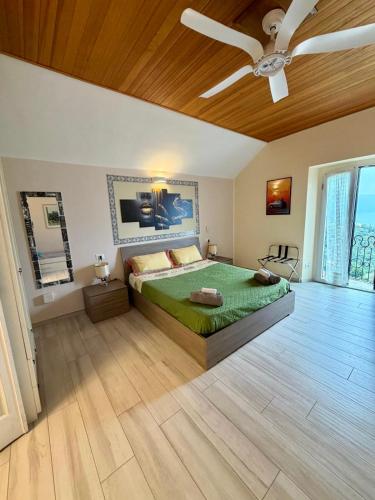 a bedroom with a bed and a ceiling fan at Villa Silvana in Perledo
