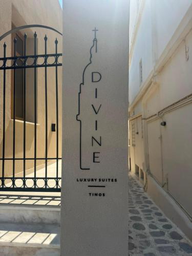 a sign on a pole in front of a gate at Divine Suites Tinos in Tinos
