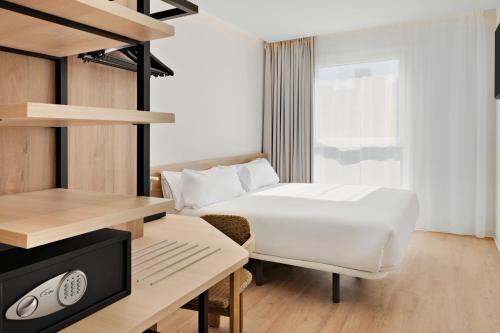 a hotel room with a bed and a desk at B&B HOTEL Madrid San Fermin in Madrid