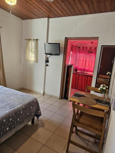 a bedroom with a bed and a table and a tv at Terraza Perito Moreno in Villa Carlos Paz