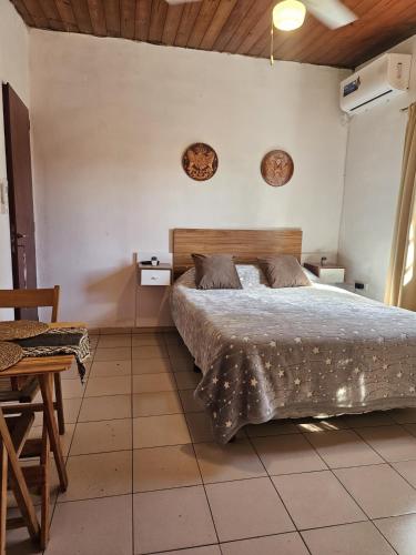 a bedroom with a bed and a table at Terraza Perito Moreno in Villa Carlos Paz