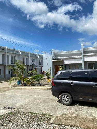a black van parked in front of a building at Two Br-House with Carport in Ormoc