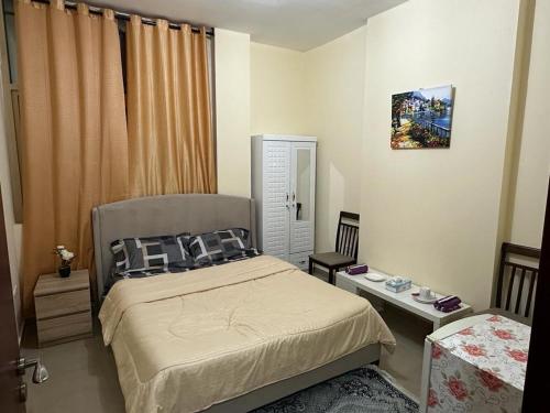 a small bedroom with a bed and a mirror at Fabulous Room in Muşaffaḩ