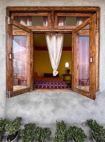 a room with a window with a bed in it at Dawaipani Sona Homestay in Jālāpahār