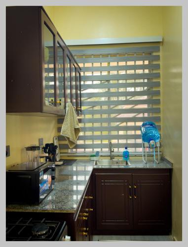 a kitchen with a sink and a window in a kitchen at HM Homes in Morogoro