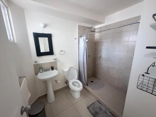 a bathroom with a toilet and a shower and a sink at Executive Apartment for 6 people in El Colorado