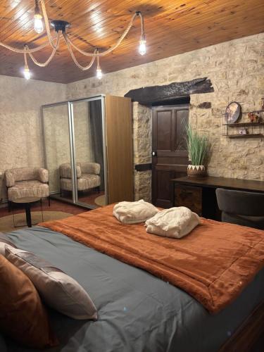 a bedroom with a large bed with two pillows on it at Hélios ranch in Varennes-le-Grand