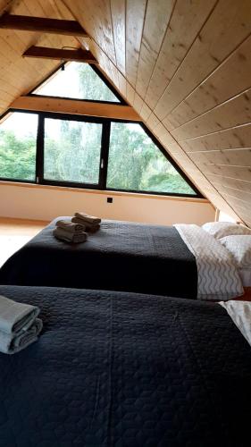 a bed in a room with a large window at iDILe in Râșca