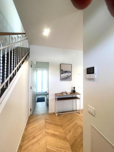 a hallway with a desk and stairs in a house at Le Port Vieux in Pesaro