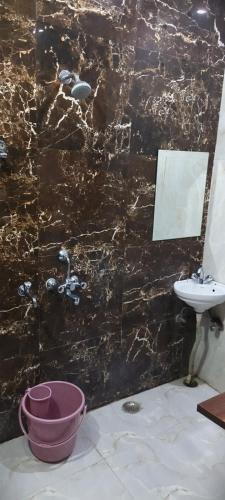 a bathroom with a sink and a toilet and a mirror at The duggar villa in Jammu