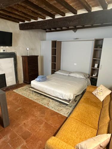 a large bedroom with a bed and a couch at Casa Michele in Pontremoli