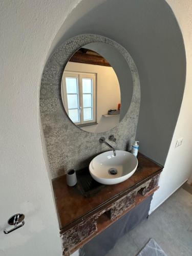 a bathroom with a sink and a mirror at Casa Michele in Pontremoli