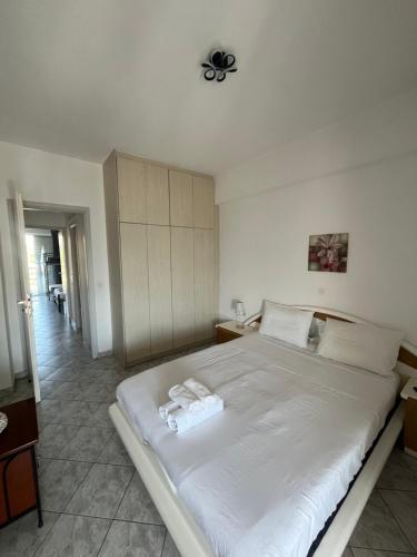 a bedroom with a large white bed with towels on it at Paradise House in Lefkandi Chalkidas