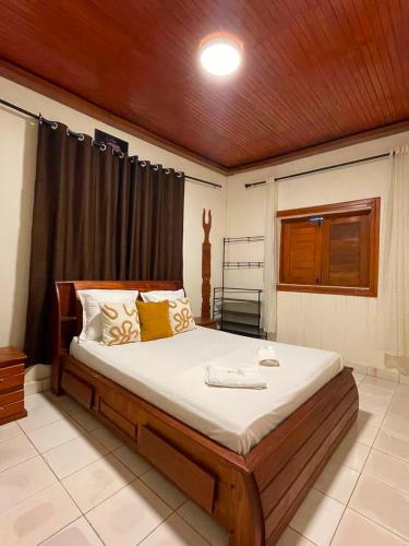 a bedroom with a large bed in a room at Villa REEL in Morondava