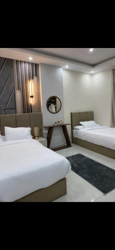 a hotel room with two beds and a mirror at Tetou Hotel Cairo in Cairo