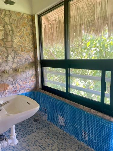 a bathroom with a sink and a window at Villa del Mar in Zipolite