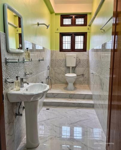 a bathroom with a sink and a toilet at Nirvana homes in North Lakhimpur