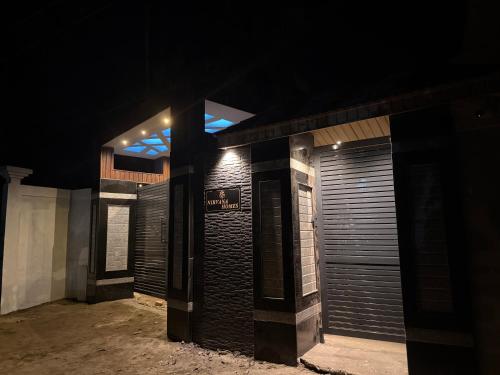 a night view of a building with closed doors at Nirvana homes in North Lakhimpur