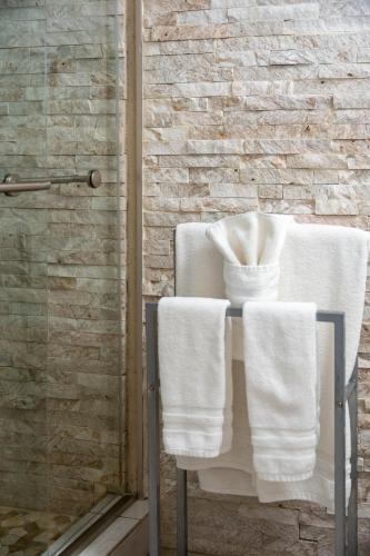 a bathroom with two white towels on a chair at Turtle Beach Resort in Siesta Key