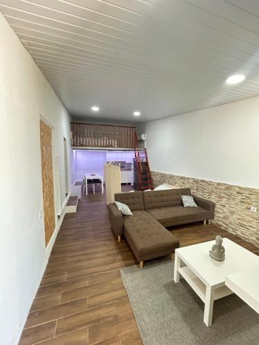 a living room with a couch and a table at Sky carvoeiro in Mação