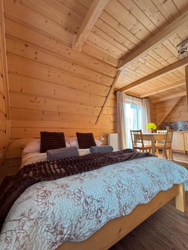 a bedroom with a bed in a log cabin at Pokoje goscinne u Jozka in Chochołów