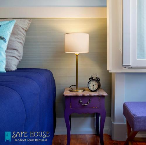 a bedroom with a bed and a table with a lamp at Safe House in Lisbon