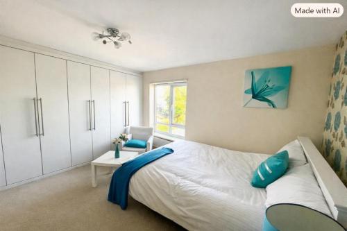 a bedroom with a bed and a chair and a window at The Rosewood in Grays Thurrock