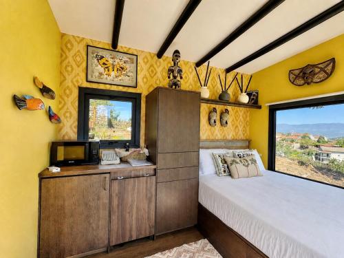 a bedroom with a bed and a window at Tiny Escape in São Miguel do Mato