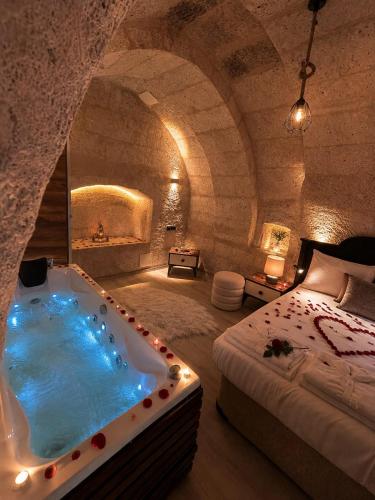 a bedroom with a bath tub in a stone room at novela in stone house in Uçhisar