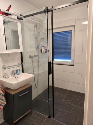 a bathroom with a shower and a sink at Buchenau an der Lahn 