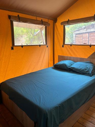a bedroom with a bed in a room with a window at Gîte les 7 saveurs in Cucugnan