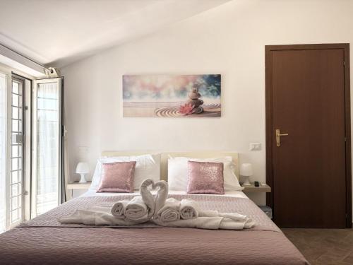 a bedroom with a bed with towels on it at Appartamento la casa di Mary Anguillara Sabazia-Lago,Relax e Roma a portata di treno in Anguillara Sabazia