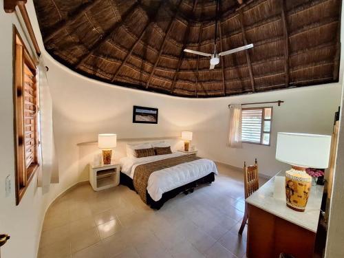 a bedroom with a bed and a large ceiling at Villas Chicanna Calakmul in Chicanna