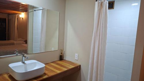 a bathroom with a sink and a shower curtain at Pucayacu Wasi in Sauce