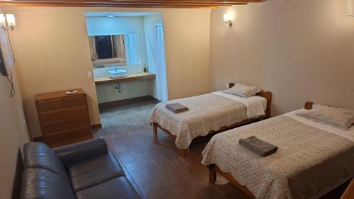 a small room with two beds and a couch at Pucayacu Wasi in Sauce