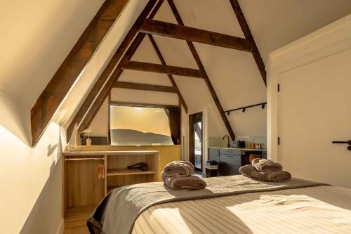 a bedroom with a bed with two towels on it at Wild Atlantic Pods in Portmagee
