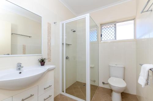 a white bathroom with a sink and a toilet at Como Apartments Gladstone in Gladstone
