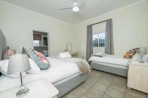 a bedroom with two beds and a window at Donkieshoek Accommodation & Campsite, Welgemoed Street, Calvinia in Calvinia