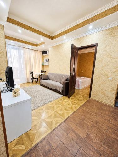 a living room with a couch and a mirror at Historic Centre Apartment Kutaisi in Kutaisi