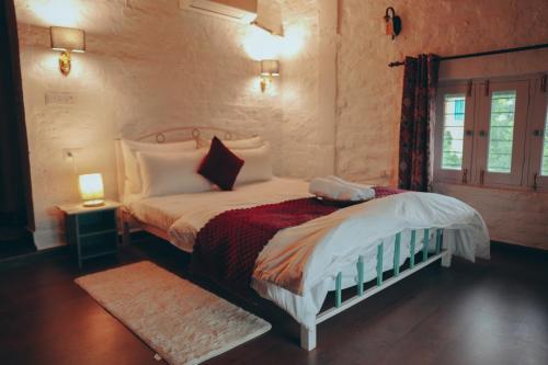 a bedroom with a bed and a window at Mellowmine Premier in Kokliyal Gaon